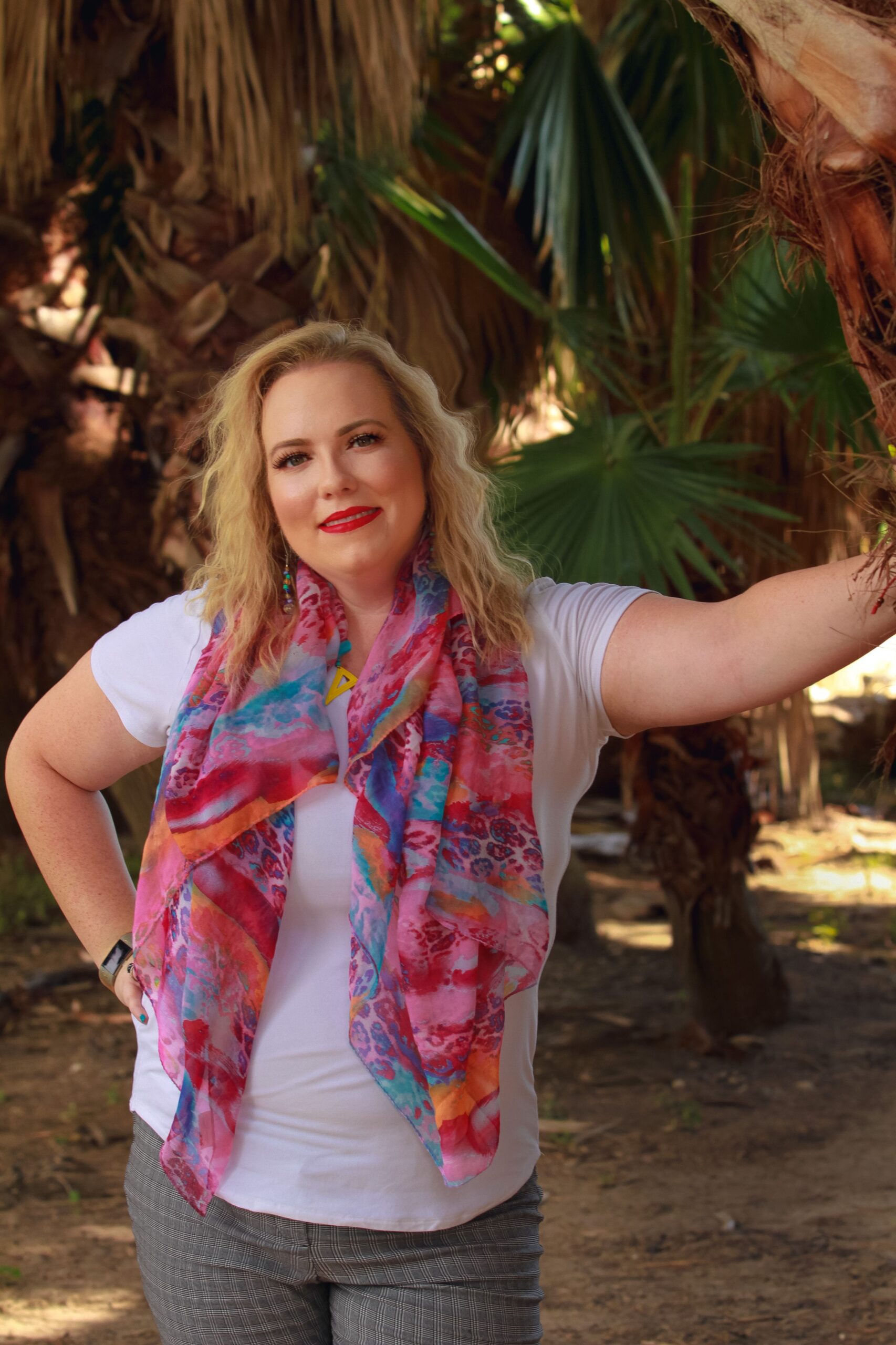 Dr. Nichole Vincent, licensed clinical psychologist, smiling and standing outdoors wearing a colorful scarf — offering online therapy for adults across 42 PSYPACT states